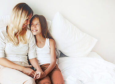 Mother with blonde hair and her daughter holding hands